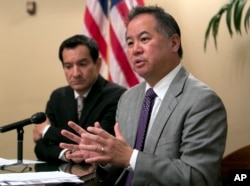 FILE - California Assemblyman Phil Ting, D-San Francisco, right, discusses the state budget in Sacramento, June 13, 2017. In 2016, Gov. Jerry Brown vetoed a bill by Ting that would have expanded the list of those who can seek gun violence restraining orders to include, among others, employees of high schools and colleges. The school shooting in Parkland, Fla., on Feb. 14, 2018, revived the debate about red flag laws. Ting said he plans to reintroduce the bill.