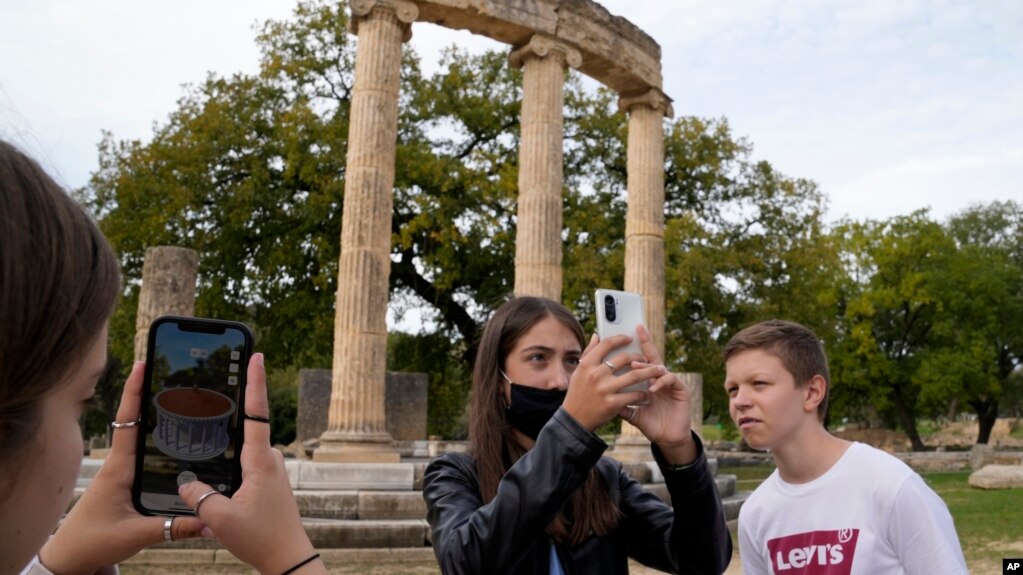 School students use a mobile app at the ancient site of Olympia, southwestern Greece, Wednesday, Nov. 10, 2021. (AP Photo/Thanassis Stavrakis)