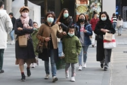 People wear face masks as they visit a shopping district in Taipei, Taiwan, Friday, Jan. 31, 2020. People wear face masks as they walk through a shopping mall in Taipei, Taiwan, Friday, Jan. 31, 2020. According to the Taiwan Centers of Disease Control (CDC) Friday, the tenth case diagnosed with the new coronavirus has been confirmed in Taiwan. (AP Photo/Chiang Ying-ying)