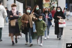 People wear face masks as they visit a shopping district in Taipei, Taiwan, Friday, Jan. 31, 2020. People wear face masks as they walk through a shopping mall in Taipei, Taiwan, Friday, Jan. 31, 2020. According to the Taiwan Centers of Disease Control (CDC) Friday, the tenth case diagnosed with the new coronavirus has been confirmed in Taiwan. (AP Photo/Chiang Ying-ying)
