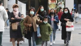 People wear face masks as they visit a shopping district in Taipei, Taiwan, Friday, Jan. 31, 2020. People wear face masks as they walk through a shopping mall in Taipei, Taiwan, Friday, Jan. 31, 2020. According to the Taiwan Centers of Disease Control (CDC) Friday, the tenth case diagnosed with the new coronavirus has been confirmed in Taiwan. (AP Photo/Chiang Ying-ying)