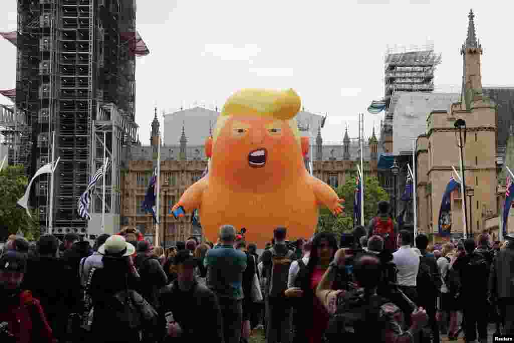 A &quot;Baby Trump&quot; balloon is seen over demonstrators as they participate in an anti-Trump protest in London.