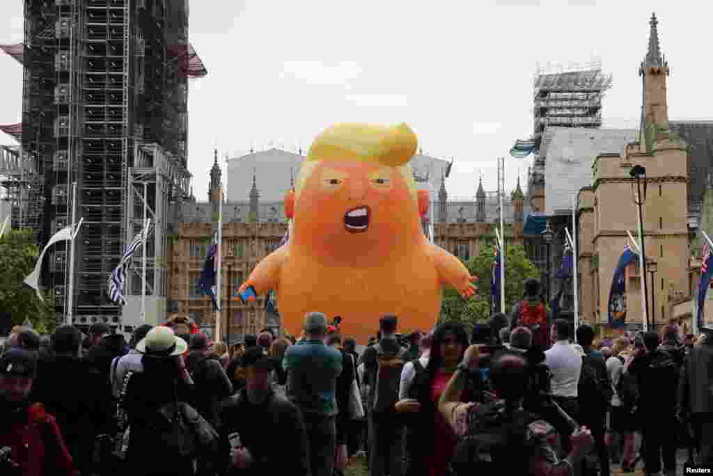 A "Baby Trump" balloon is seen over demonstrators as they take part in an anti-Trump protest in London.