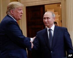 FILE - U.S. President Donald Trump, left, and Russian President Vladimir Putin, right, shake hands at the conclusion of their joint news conference at the Presidential Palace in Helsinki, Finland, July 16, 2018.