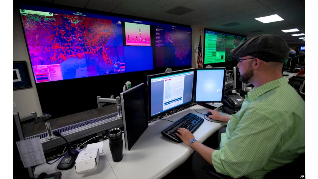 FILE - A specialist works at the National Cybersecurity and Communications Integration Center in Arlington, Virginia, Sept. 9, 2014.