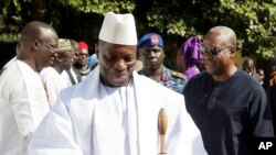 FILE - In this photo released by the Nigeria State House, Gambia's Yahya Jammeh, walk along side with Nigeria President Muhammadu Buhari (not seen), upon arrival in Banjul, Jan.13, 2017. 
