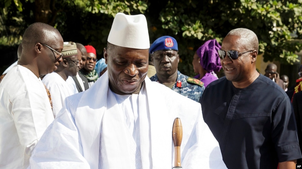 FILE - In this photo released by the Nigeria State House, Gambia's Yahya Jammeh, walk along side with Nigeria President Muhammadu Buhari (not seen), upon arrival in Banjul, Jan.13, 2017.