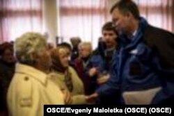 Александр Гуґ розмовляє з українськими біженцями на Донбасі