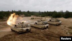 U.S. M1 Abrams tanks fire during the "Saber Strike" NATO military exercise in Adazi, Latvia, June 11, 2016. REUTERS/Ints Kalnins - S1AETJHGYOAA