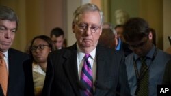 Senate Republican Majority Leader Mitch McConnell of Kentucky, joined by colleagues, pauses as he holds his first news conference since the Republican health care bill collapsed, Aug. 1, 2017, on Capitol Hill in Washington.