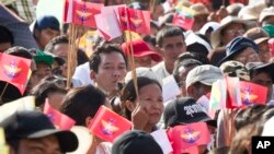 Participants holding national and military flags attend a march supporting the country's military and government servants, Oct. 29, 2017, in Yangon, Myanmar. 