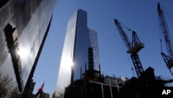 4 World Trade Center, center, towers over construction cranes at the trade center site, Nov. 13, 2013, in New York City