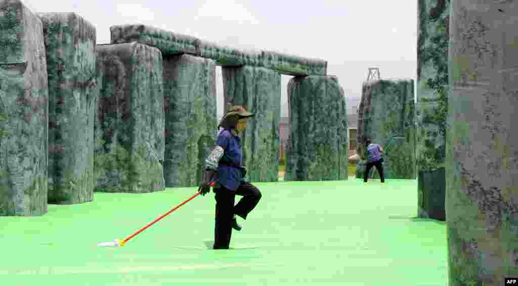 Workers clean a sculpture by British artist Jeremy Deller titled &quot;Sacrilege&quot; at the Mobile M+: Inflation! exhibition in Hong Kong. Mobile M+: Inflation! presented six giant inflatable sculptures installed next to M+, Hong Kong&rsquo;s future museum for visual culture, and will open to the public from April 25 &ndash; June 9.