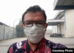 Arif Rahman Hakim, warga Pekanbaru yang harus bekerja dengan mengenakan masker. (Foto: Arif RH)