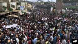 Thousands of Pakistani mourners attend a funeral procession for victims of a bombing Friday in Shikarpur, some 500 kilometers (310 miles) north of Pakistan's port city of Karachi, Jan. 31, 2015.