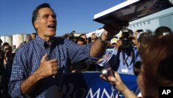 Republican presidential candidate and former Massachusetts Governor Mitt Romney greets audience members at a campaign rally in Panama City, Florida January 28, 2012.
