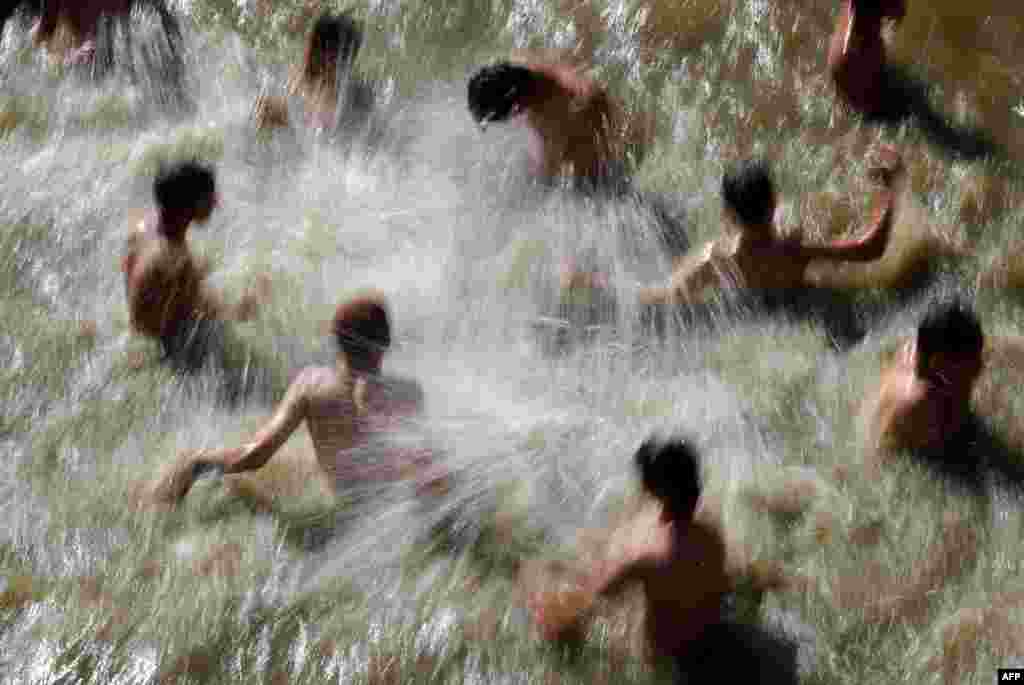 Young Israelis swim and play in a natural pool in the village of Lifta, which was abandoned during fighting in the 1948 Arab-Israeli war and lies on the northwestern outskirts of Jerusalem.