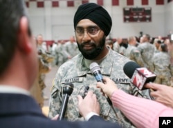 FILE - U.S. Army Capt. Tejdeep Singh Rattan speaks to journalists at a U.S. Army officer basic training graduation ceremony at Fort Sam Houston in San Antonio, March 22, 2010. Rattan was the first Sikh allowed to complete officer basic training while wearing the traditional turban and full beard since the Army altered the dress code, which had made exceptions for Sikh soldiers, in 1984.