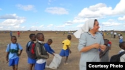 A Roman Catholic sister caught in action with children in Mashonaland West Province