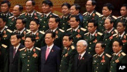 Vietnamese President Truong Tan Sang, front row left, Prime Minister Nguyen Tan Dung, front row third left, and Communist Party General Secretary Nguyen Phu Trong, front row third right, pose for a group photo with the Army generals after the election for the new Central Committee in Hanoi, Vietnam, Tuesday, Jan. 26, 2016.