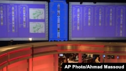 Early results of South African elections are displayed on electric boards at the Independent Electoral Commission Results Center, in Pretoria, South Africa, Thursday, May 8, 2014. Results released by the national election commission showed the African Nat