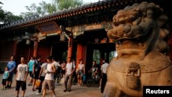 People enter and leave the gate of Peking University in Beijing, China, July 27, 2016. REUTERS/Thomas Peter