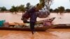 Un homme transporte ses effets personnels sur une pirogue lors d'une inondation dans un district de Niamey, au Niger, le 5 septembre 2013.