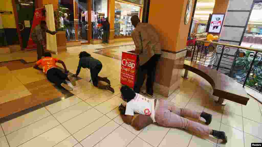 People scramble for safety as armed police hunt gunmen who attacked Westgate Shopping Mall in Nairobi, September 21, 2013.