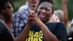 Cara McClure, of Birmingham, Alabama, cries during a solidarity gathering Aug. 13, 2017, in Birmingham for the victims in Charlottesville, Virginia.