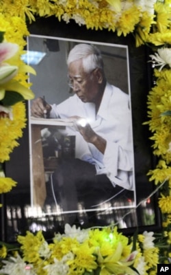 A portrait of Vann Nath, an artist who survived Khmer Rouge prison, is displayed on an altar during his funeral in Phnom Penh, Cambodia, Tuesday, Sept. 6, 2011. Vann Nath, who was among only seven people to survive Cambodia's most notorious prison of the