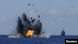 The Indonesian Navy destroyed a foreign fishing boat it had seized this year. The move is part of an effort to increase enforcement in waters Indonesia claims as its own.
