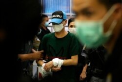 Thai police escort former police station chief Thitisant Utthanaphon, known as "Jo Ferrari," as they leave the Crime Suppression Division in Bangkok, Thailand, Aug. 26, 2021.