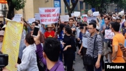 Protesters hold a banner which reads "No Leasing Land to China even for Anytime" during a demonstration against a draft law on the Special Economic Zone in Hanoi, Vietnam, June 10, 2018.