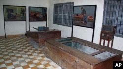 Paintings by human rights icon and artists Vann Nath depicting how torture devices were used hang on the walls of Tuol Sleng Prison in Phnom Penh, Cambodia, June 2011.