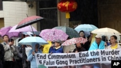 FILE - Demonstrators with the organization End the Persecution of Falun Gong Practitioners in China protest outside the Chinese Consulate in Los Angeles, Feb. 15, 2012.