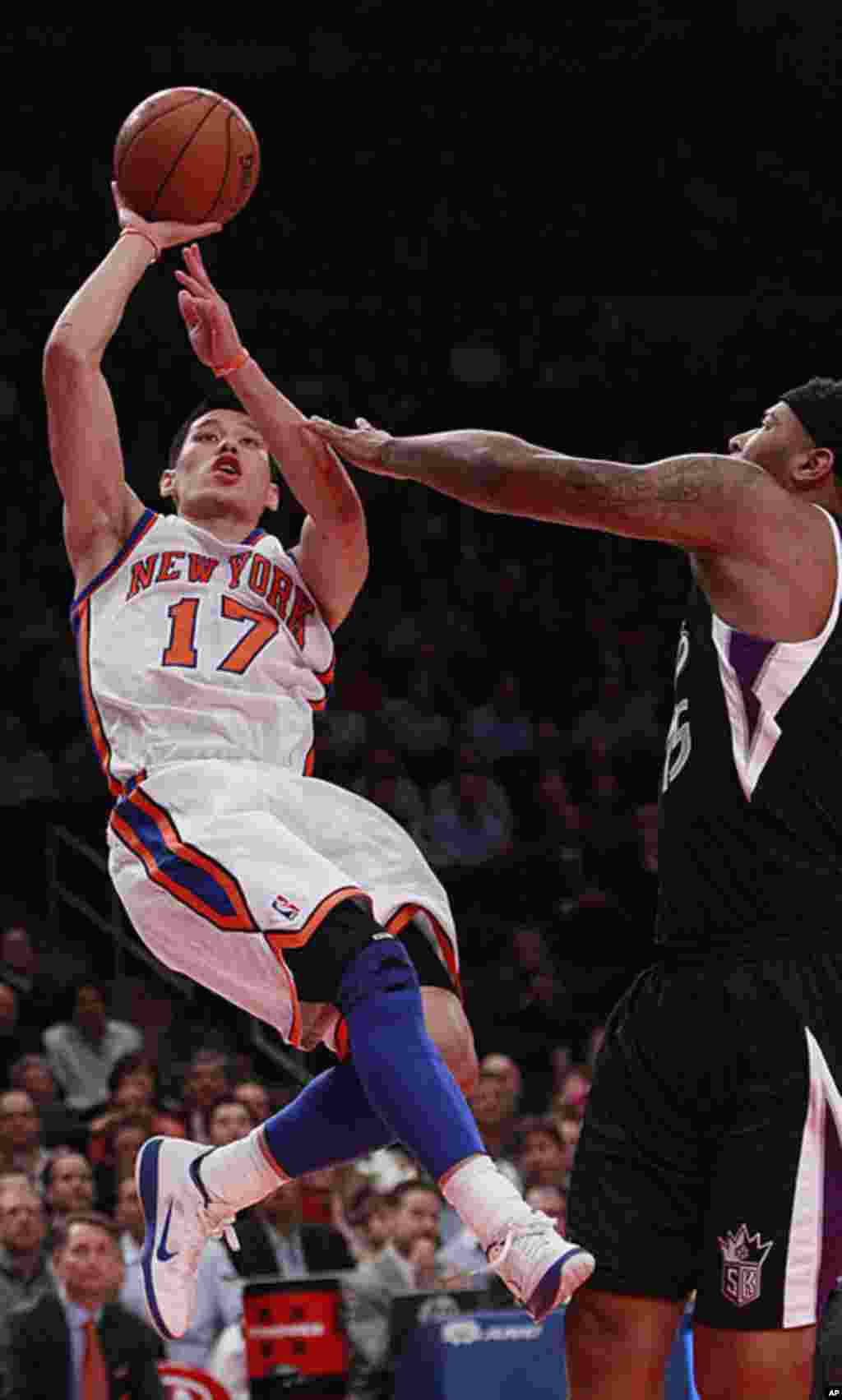 New York Knicks' Jeremy Lin shoots over Sacramento Kings' DeMarcus Cousins during an NBA basketball game February 15, 2012, in New York. (AP)