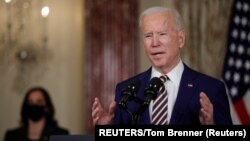 U.S. President Joe Biden delivers a foreign policy address as Vice President Kamala Harris listens during a visit to the State Department in Washington, U.S., February 4, 2021. REUTERS/Tom Brenner