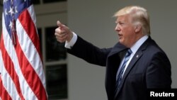 FILE - U.S. President Donald Trump gives a thumbs up during a National Day of Prayer event at the Rose Garden of the White House in Washington, May 4, 2017.