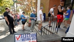 People arrive to cast their ballot for 2016 elections at a polling station as early voting begins in North Carolina, in Carrboro, North Carolina, Oct. 20, 2016. 