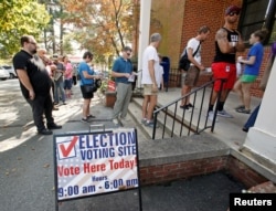 People arrive to cast their ballot for 2016 elections at a polling station as early voting begins in North Carolina, in Carrboro, North Carolina, Oct. 20, 2016.