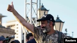 FILE - Armenian opposition leader Nikol Pashinyan gestures to his supporters at a rally in Yerevan, Armenia, May 2, 2018. 
