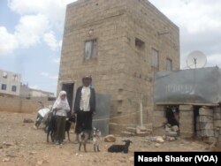 Hamid Al Wesabi and Safia are pictured by their home after a blast nearby shook the house and broke the windows in Sanaa, Yemen, April 20, 2019.