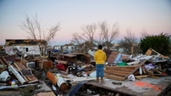 Nicolaus Kruse, 23, stands amongst the rubble of the home he grew up in after a devastating outbreak of tornadoes ripped through several U.S. states, in Mayfield, Kentucky, Dec.13, 2021.