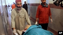 Petugas medis Afghanistan membawa jenazah pekerja lembaga bantuan yang menjadi korban serangan militan (foto: dok). 