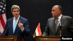 U.S. Secretary of State John Kerry, left, speaks during a joint news conference with Egyptian Foreign Minister Sameh Shoukry following his meeting with Egyptian President Abdel-Fattah el-Sissi in Cairo, Egypt, June 22, 2014.