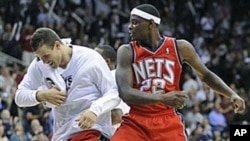New Jersey Nets' Anthony Morrow, right, celebrates with teammate Kris Humphries after hitting a game-winning three-point shot in a game against the Detroit Pistons, 27 Oct 2010
