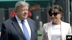 Viktor and Amalija Knavs listen as their attorney makes a statement in New York, Aug. 9, 2018. First lady Melania Trump's parents have been sworn in as U.S. citizens. A lawyer for the Knavses says the Slovenian couple took the citizenship oath on Thursday