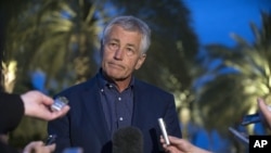 U.S. Secretary of Defense Chuck Hagel speaks with reporters after reading a statement on chemical weapon use in Syria during a press conference in Abu Dhabi, United Arab Emirates, April 25, 2013.