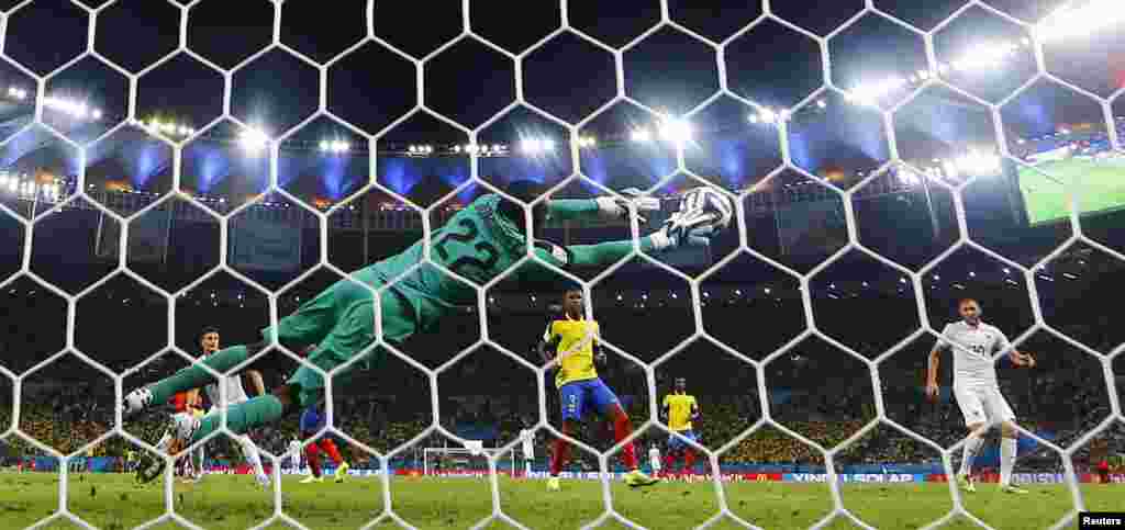 Ecuadorian goalkeeper Alexander Dominguez keeps the game close with this remarkable save against France at the Maracana stadium, in Rio de Janeiro, June 25, 2014. 