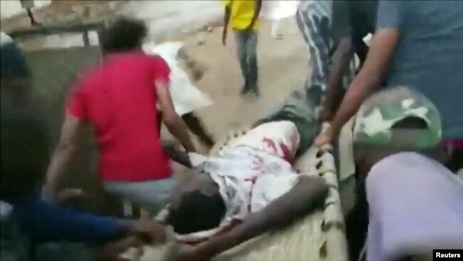 An injured man is carried on a stretcher during protests in Khartoum, Sudan, June 3, 2019 in this image taken from a video obtained from social media.
